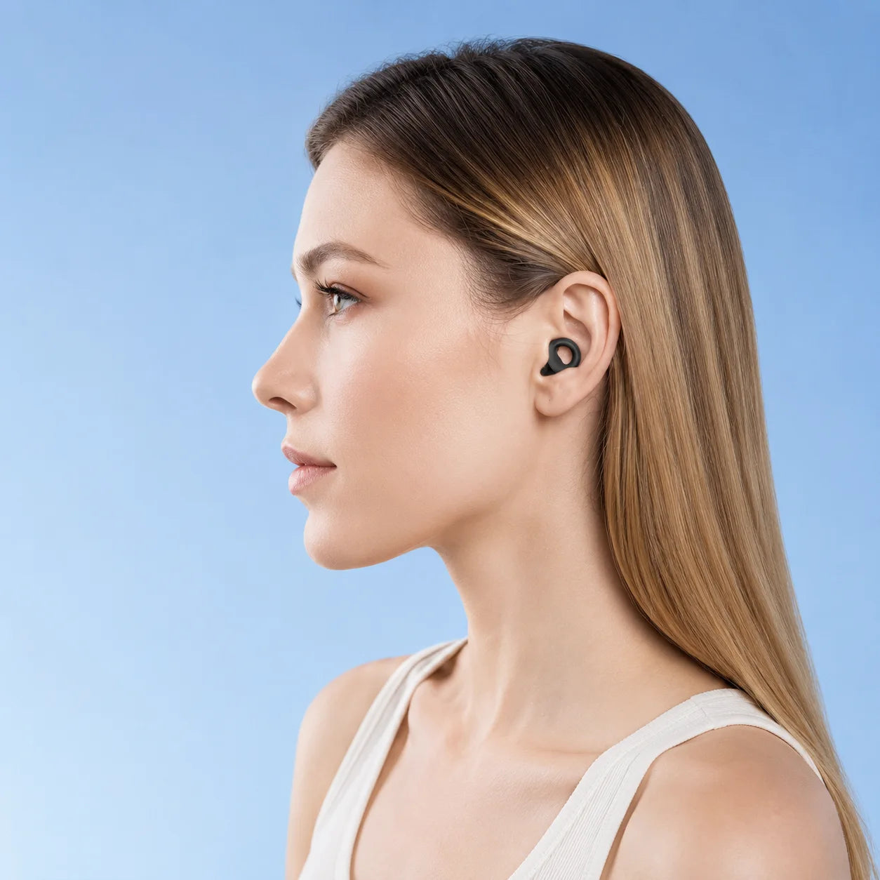 Black silicone loop earplug worn securely in the ear
