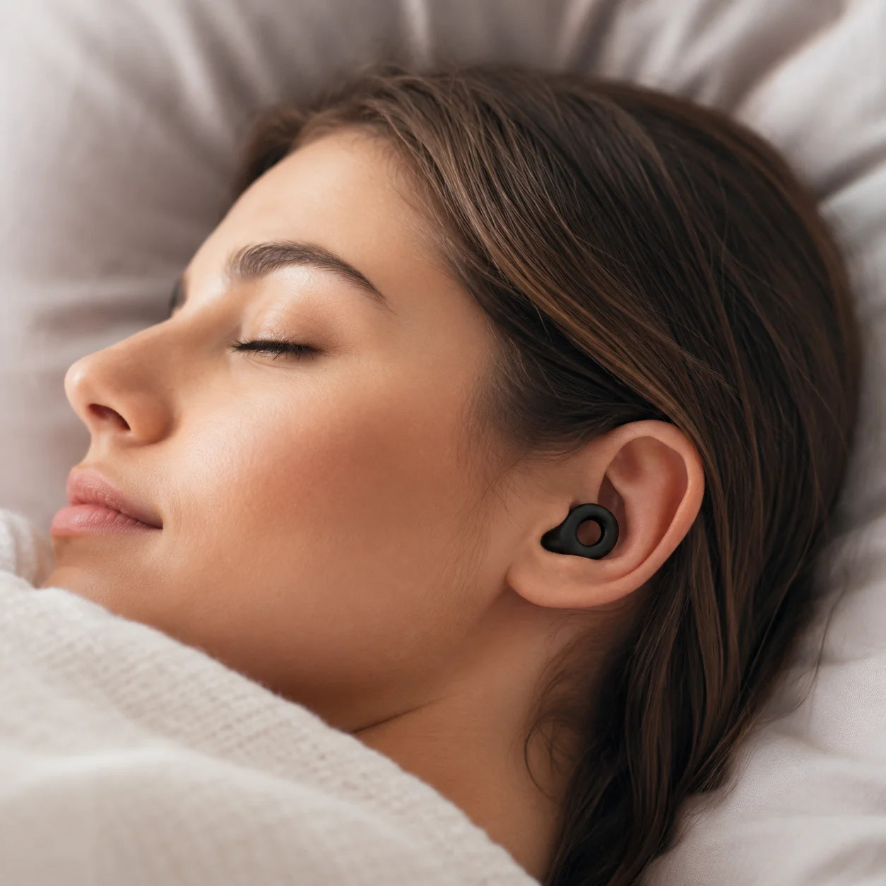 Midnight Black silicone earplugs worn while resting