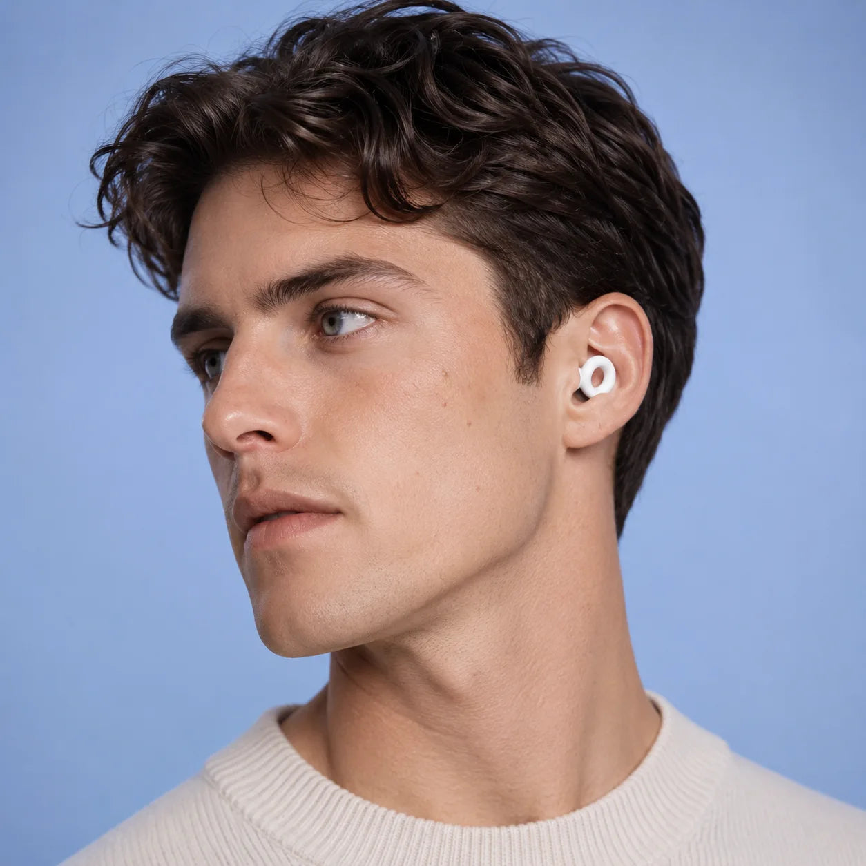 Cloud White silicone earplugs shown in the ear