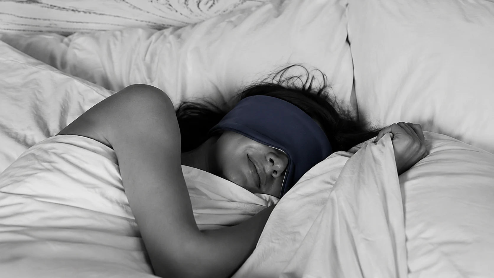 Woman sleeping comfortably in a Mellooa sleep mask