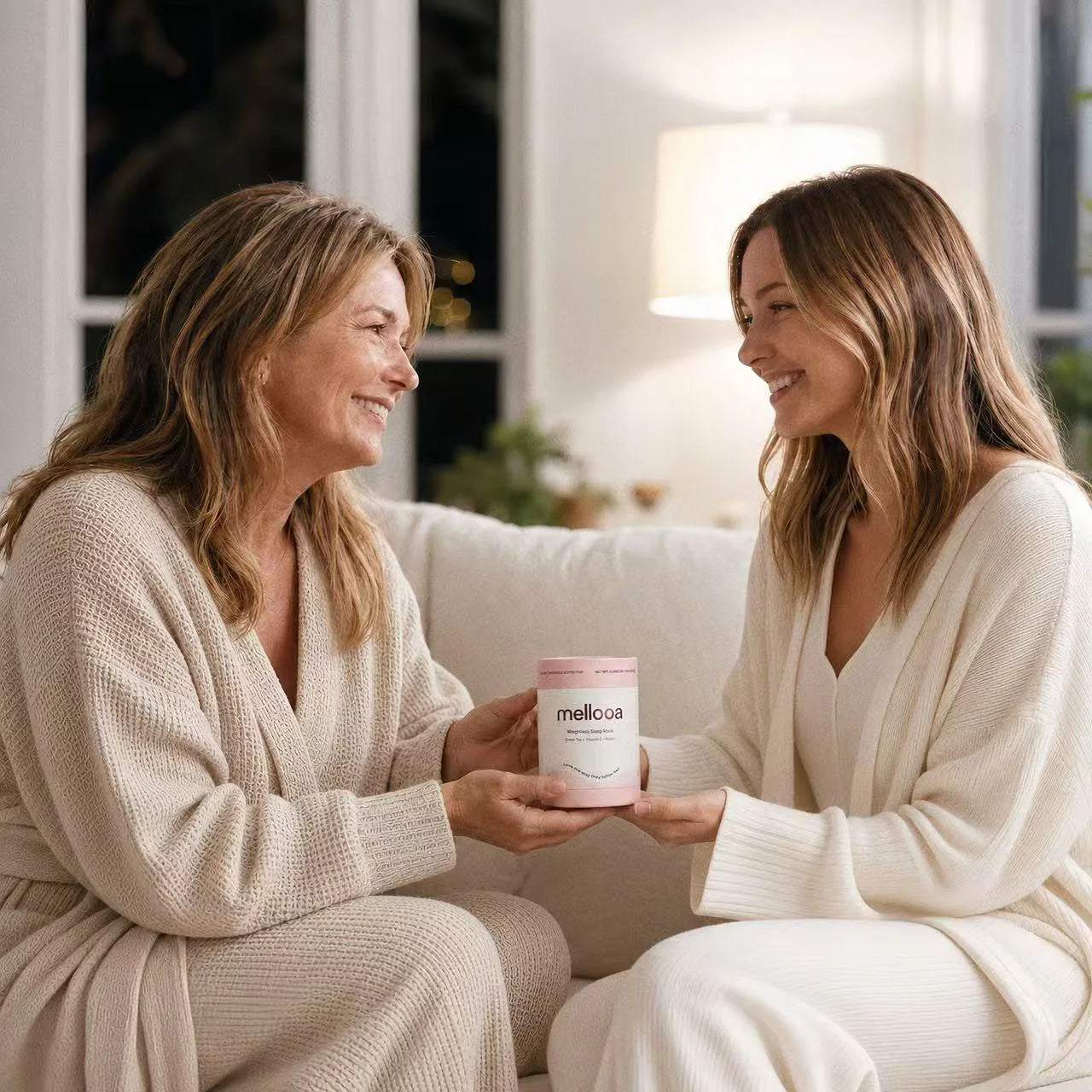 Two women sharing a Mellooa weighted sleep mask as a thoughtful gift