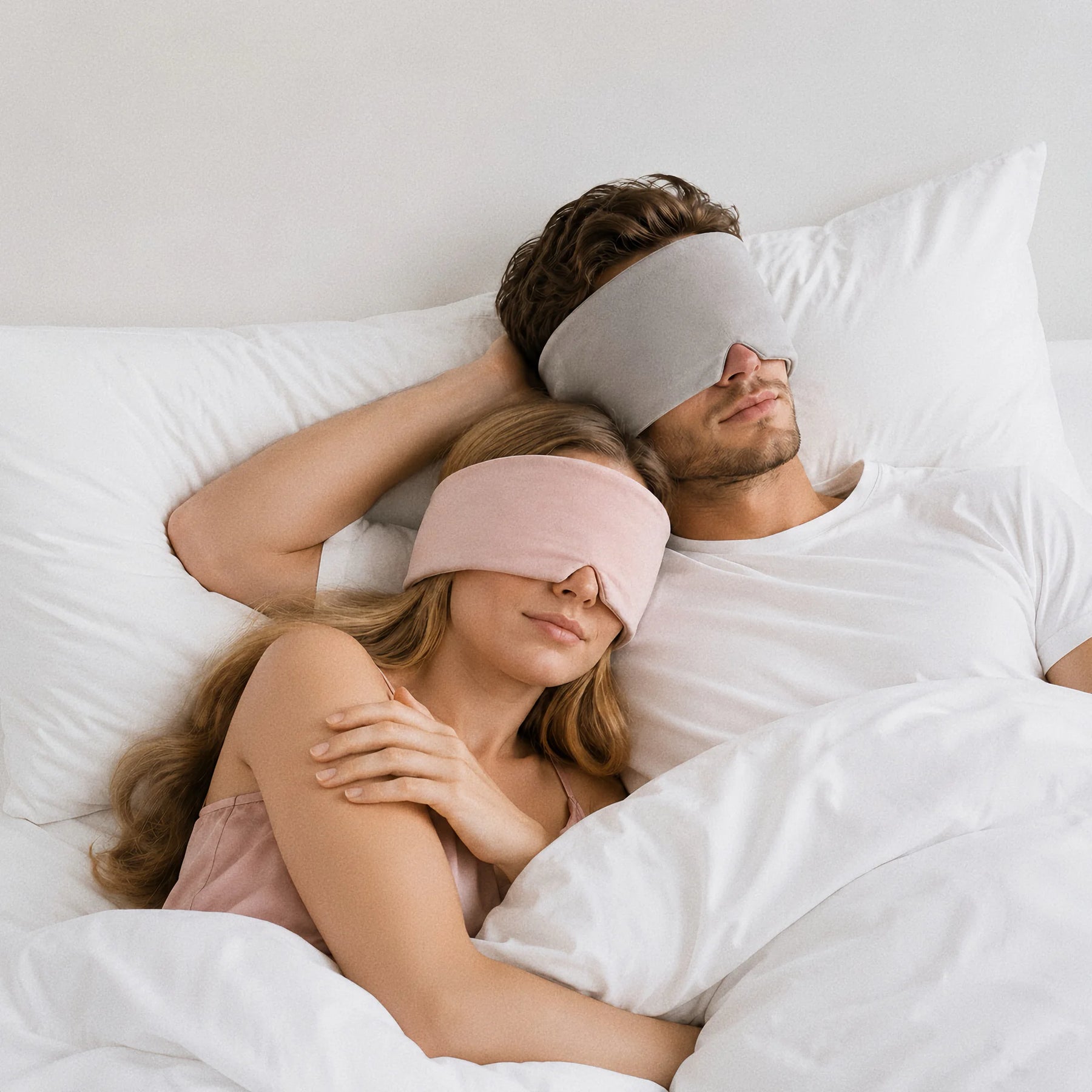 Couple resting together in Blush Pink and Warm Gray Mellooa weighted sleep masks