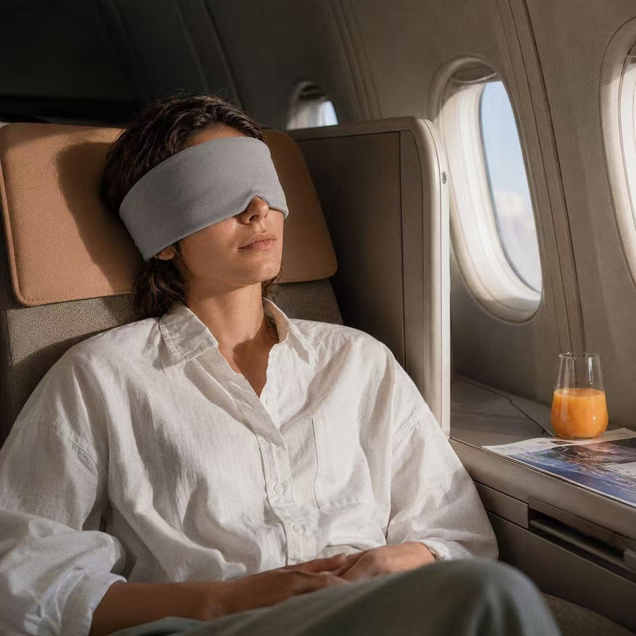 Mellooa weighted sleep mask during a quiet rest in an airplane cabin